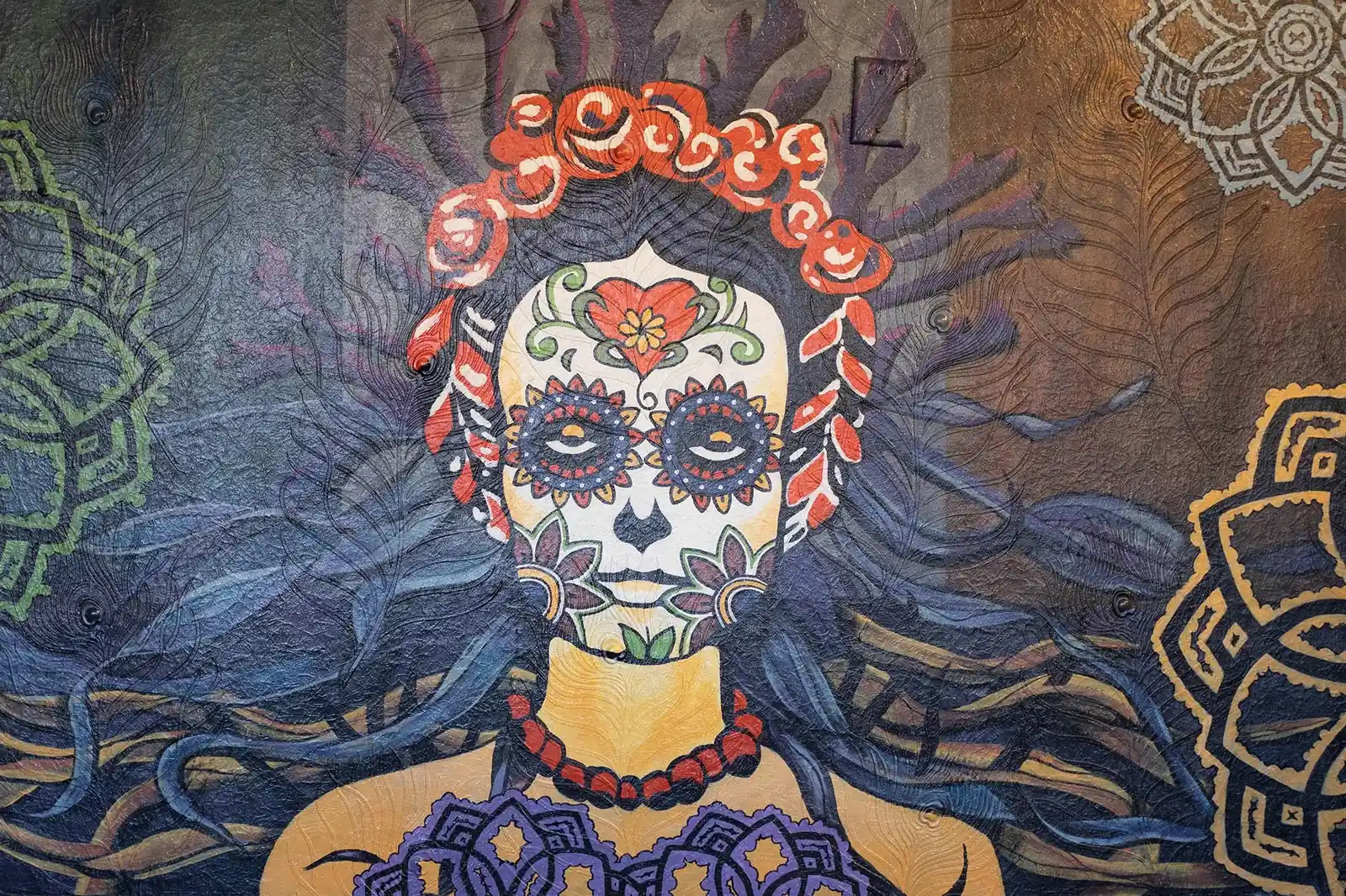 La Dama’s mural of a woman with a flower crown and colorful sugar-skull face paint